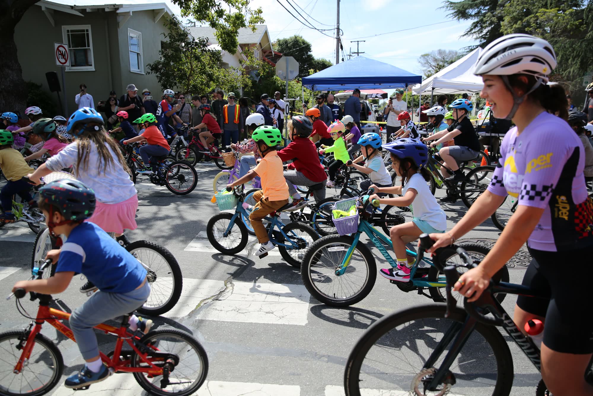 Kids riding through the crowd at the Berkeley Streets Criterium kids race