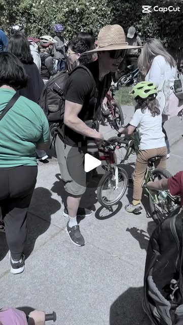 Parents and kids with small bikes and helmets gathering for the kids race at Berkeley Streets